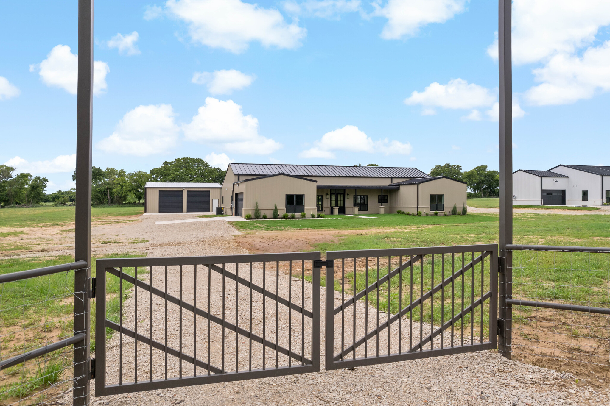 Brand new barndominium with large detached workshop on 1.62 acres in Alvarado, Texas.